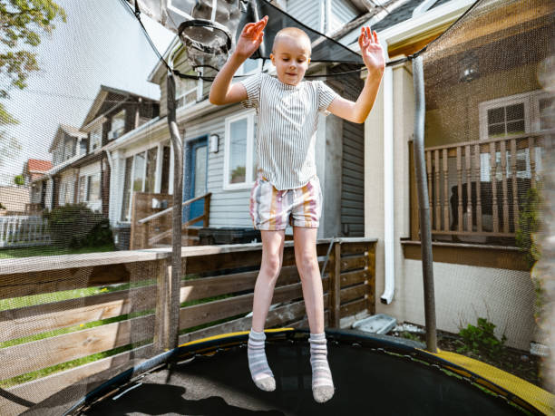 istock Young girl playing on trampoline 1318468458