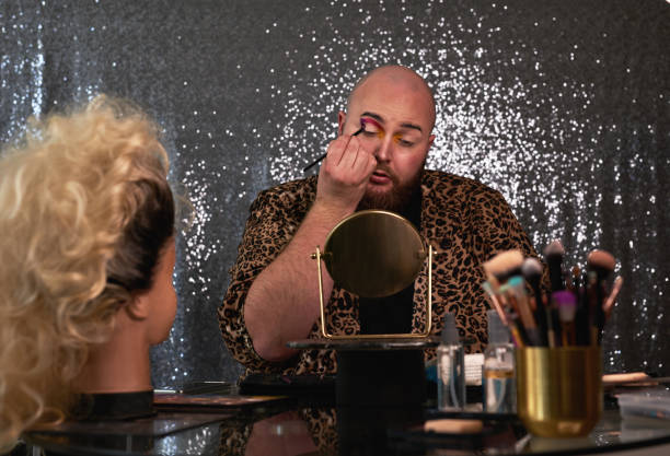 istock Shot of a young man applying theatrical makeup to his face in a studio 1318469430