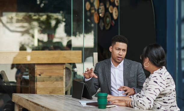 istock Businesspeople talking at a cafe table during their office break 1318469697