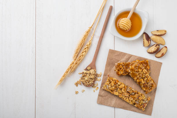 istock Homemade cereal bars with nuts, wheat, muesli, honey and copy space 1318472078