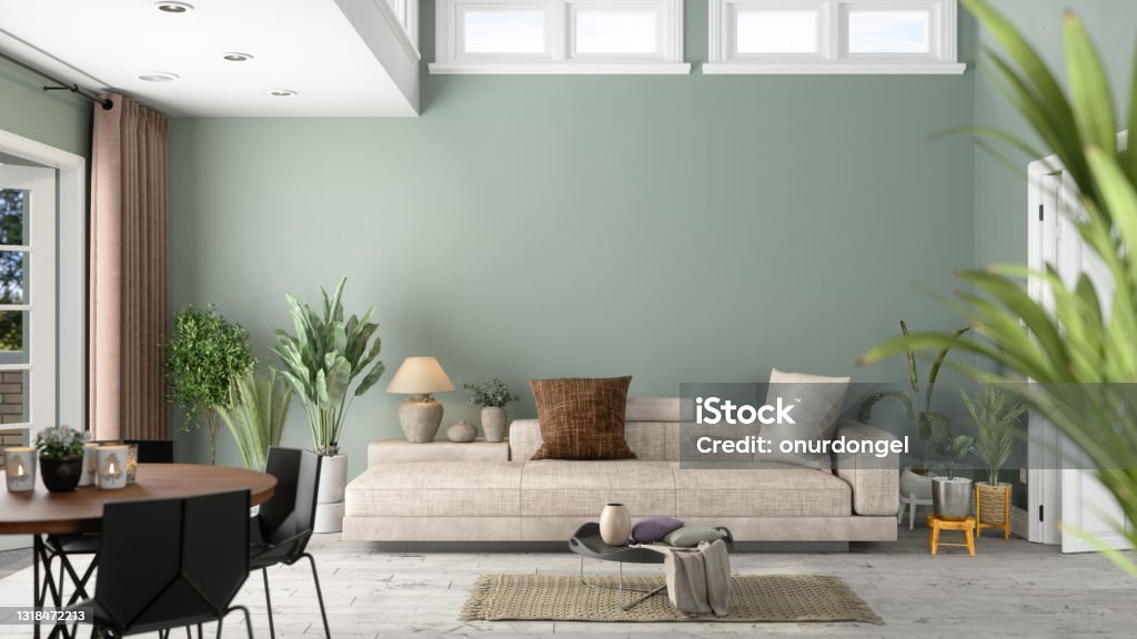 Modernes Wohnzimmer-Interieur mit grünen Pflanzen, Sofa und grünem Wandhintergrund - Lizenzfrei Wohnzimmer Stock-Foto