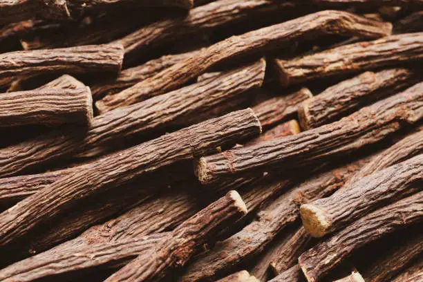 Dried sticks of liquorice root as background, closeup