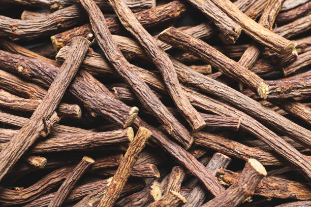 istock Dried sticks of liquorice root as background, top view 1318472321
