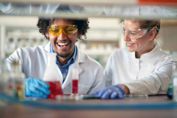 istock Young chemistry students in a protective gear work with a pleasure in the university laboratory. Science, chemistry, lab, people 1318472404