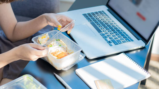 istock Young women work at home and eat meals during their work. 1318472654