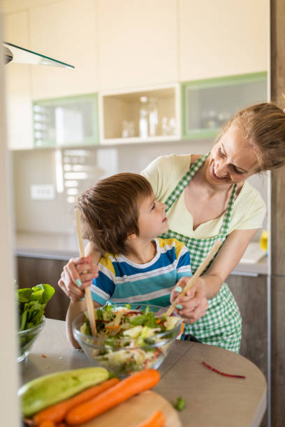 istock Boy preparing meal whit his mother 1318472968