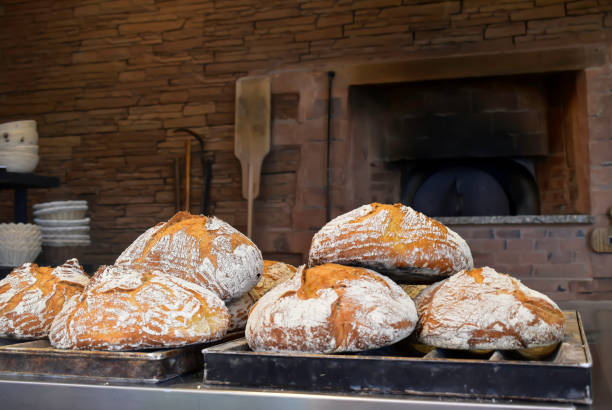 istock Freshly baked traditional breads with in background a classical oven for baking. 1318473569