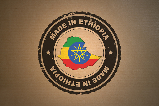 Brown paper with in its middle a retro style stamp Made in Ethiopia include the map and flag of Ethiopia.