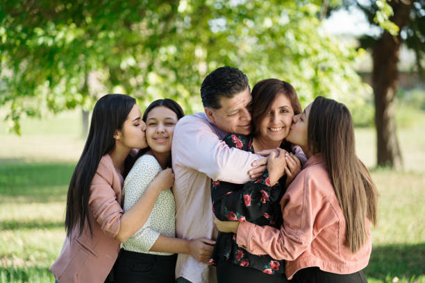 istock Affectionate family standing close together outside and smiling 1318475076