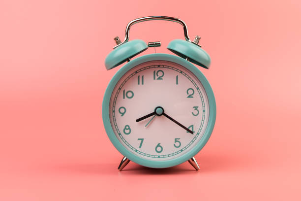 istock Old clock isolated on a pink background with space for text. Concept of time 1318476692