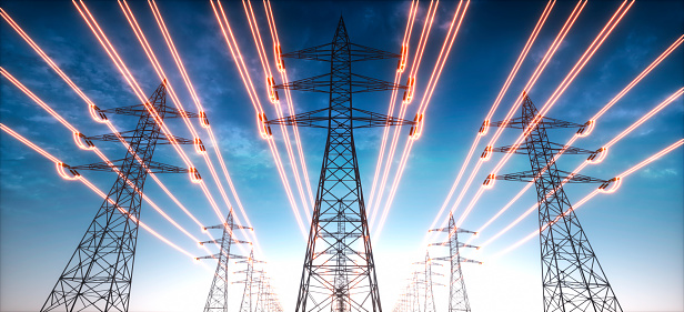 Torres de transmisión de electricidad con cables rojos brillantes photo