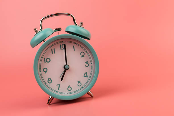 istock Old clock isolated on a pink background with space for text. Concept of time 1318477048