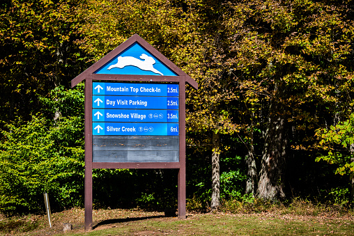 Snowshoe, USA - October 6, 2020: Information sign for West Virginia mountain ski resort town with direction for day visit parking, village and silver creek with top check-ins in colorful autumn
