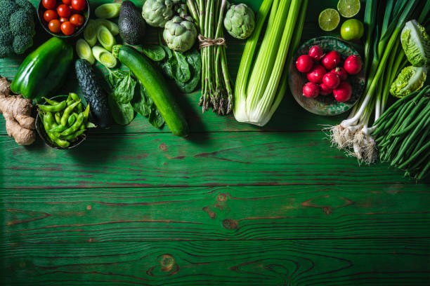 Vegan vegetables on green wooden table copy space Vegan raw vegetables on green wooden table copy space background salad fruit lettuce spring stock pictures, royalty-free photos & images