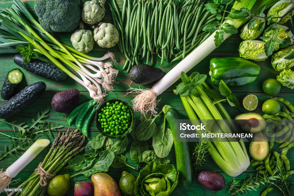 Vegan raw vegetables on green wooden table background Vegan raw vegetables on green wooden table full frame background Vegetable Stock Photo