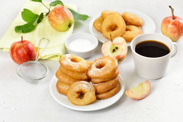 istock Apple rings on white plate, cup of black coffee 1318478208