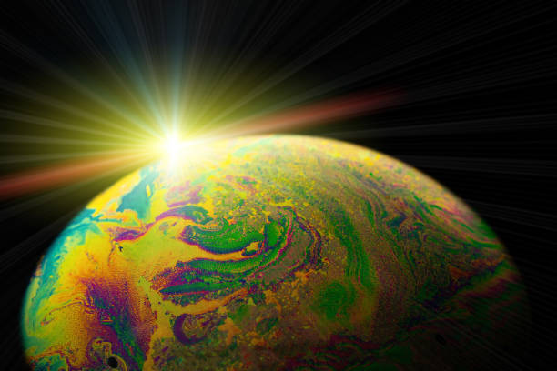 istock Vibrant universe. Abstract galaxy background with globe planet earth in universe space with sunlight on dark background. Macro of oil mixed with water. 1318480051