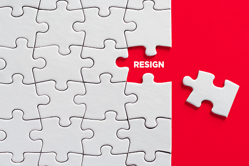 The word resign on missing puzzle piece. Resignation or to quit job concept.