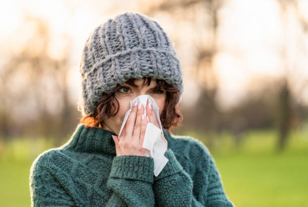 istock Woman blowing her nose 1318480825