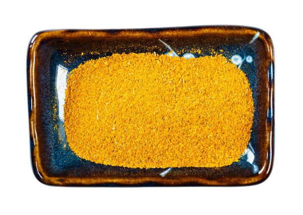 ground Dried Marigold Flowers on plate cutout top view of ground Imeretian Saffron (Dried Marigold Flowers) on rectangular plate cutout on white background substitute for saffron stock pictures, royalty-free photos & images