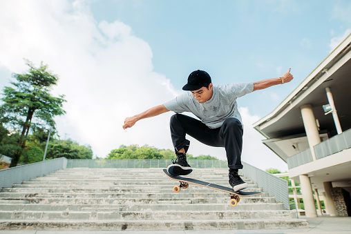 wide shot of skater jumping up from ground
