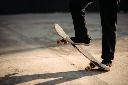crop shot of skater legs on his skateboard