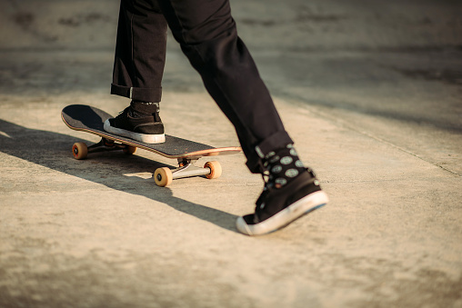 crop shot of skater legs on his skateboard