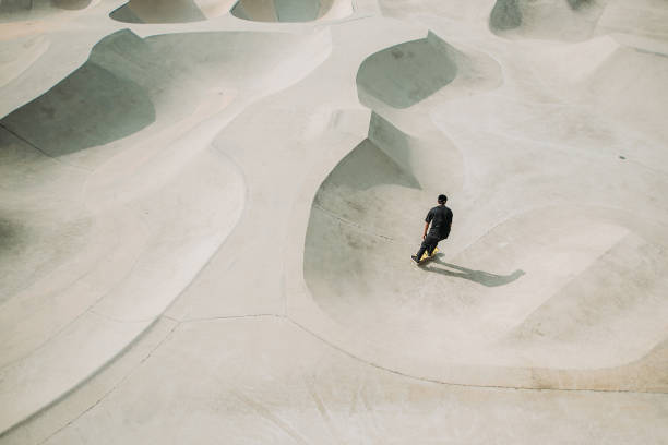 istock Asian male skateboarding in a skate park 1318482400
