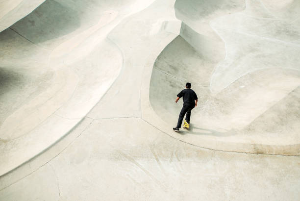istock Asian male skateboarding in a skate park 1318482406
