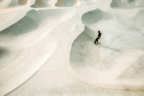 istock Asian male skateboarding in a skate park 1318482409