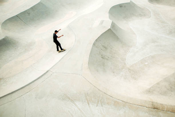 istock Asian male skateboarding in a skate park 1318482410