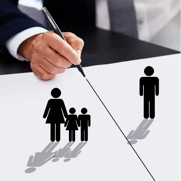 Photo of Cropped shot of a businessman drawing a dividing line between a father, his children and their mother