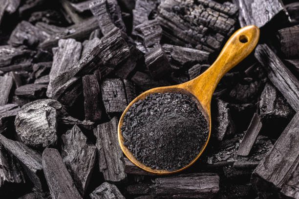 istock wooden spoon with coal dust on pieces of coal 1318483759