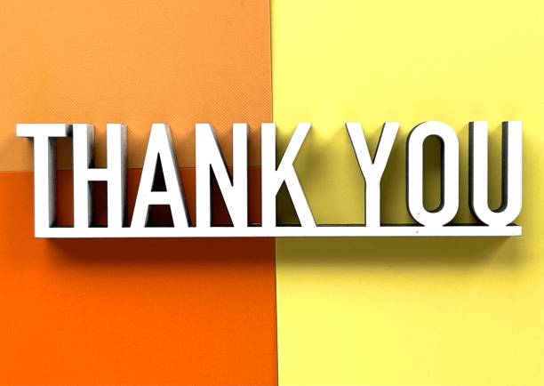 istock Thank you phrase on orange yellow background 1318487636