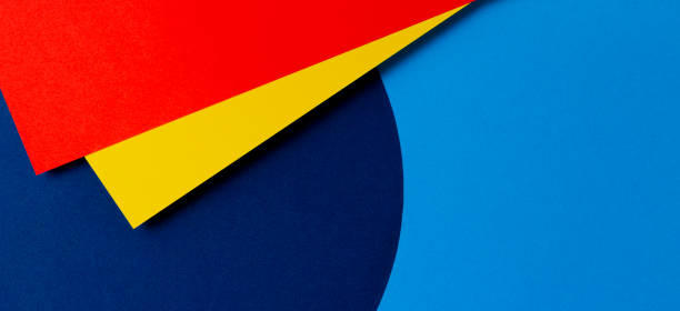 istock Abstract colored paper texture background. Minimal geometric shapes and lines in light blue, navy, red and yellow colors 1318487724