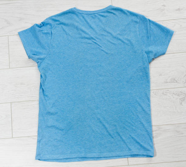 istock Blue t-shirt mock up top view, blue shirt copy space 1318488369