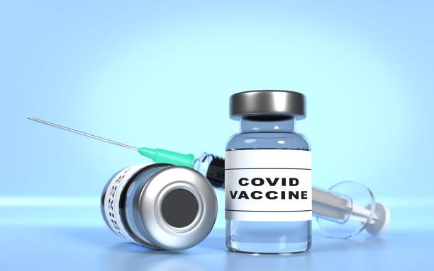 istock Covid-19 Coronavirus Vaccine with Syringe Against Blue Background 1318490945
