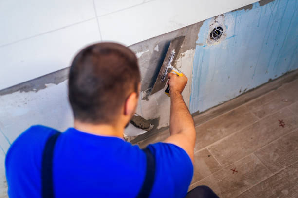 istock Tiler is applying adhesive to the kitchen wall 1318490983