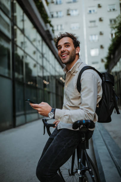 istock Happy cyclist in the city using phone 1318491928