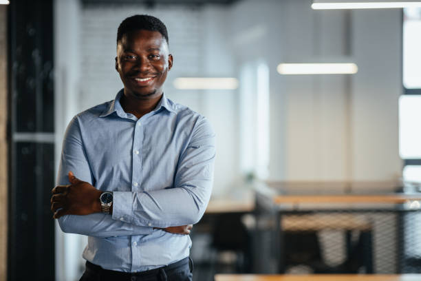 istock Businessman posing and smiling at the workplace 1318492577