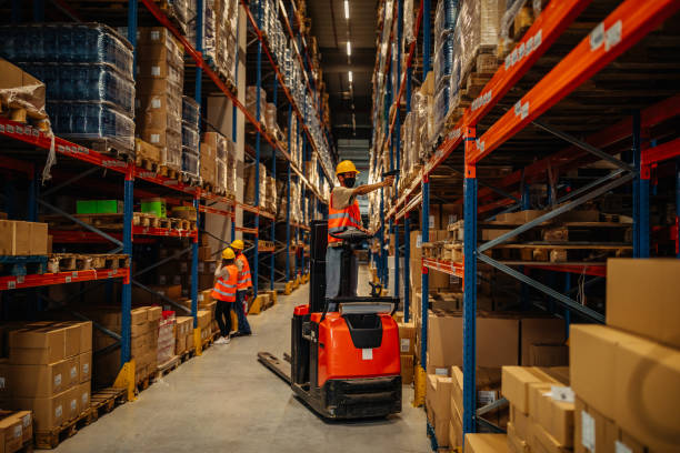 man with bar-code reader in warehouse - warehouse worker imagens e fotografias de stock