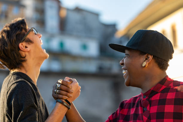 istock Two young men sharing a good joke laughing together 1318493558