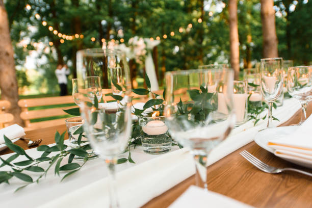 istock setting a wedding banquet in the forest. Rustic style. Green branch and candles. Celebrating a wedding 1318493628