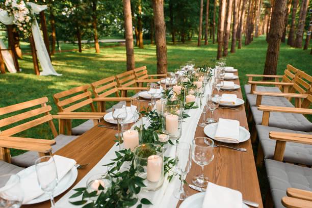 istock Rustic green branch and candles on the table. Wedding decoration. 1318493689