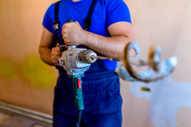 istock Paint worker with the electric paint mixer 1318494001