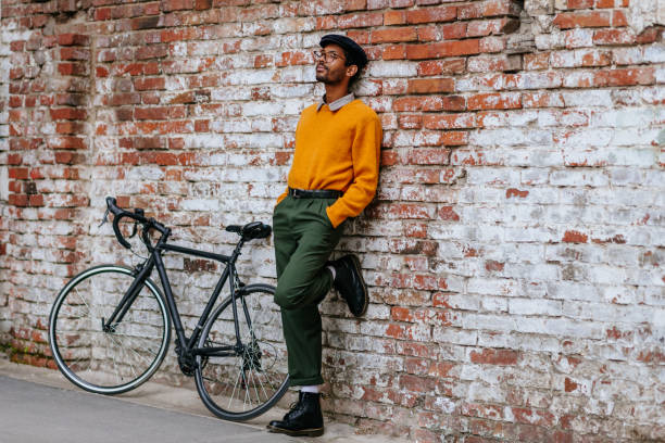 istock Young trendy guy with a bicycle in town 1318497098