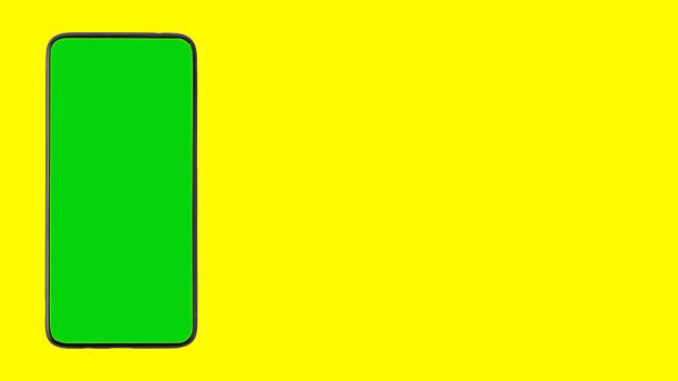 istock A smartphone with a chroma key instead of a screen on a yellow background. Isolate. Copy space 1318498304