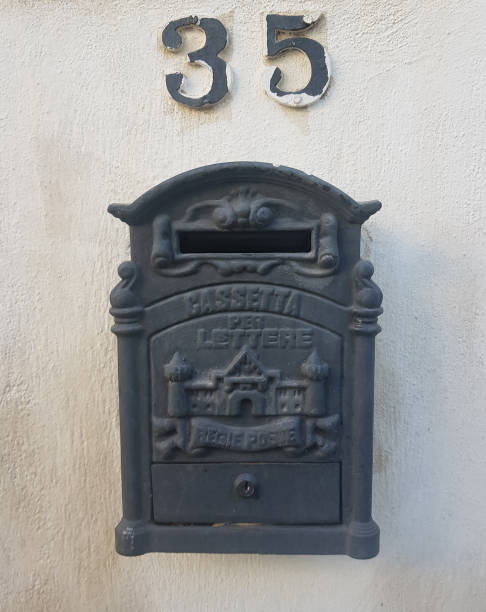 istock Black mailbox on a white wall with the number 35 on it. Mailbox. Post director 1318498487
