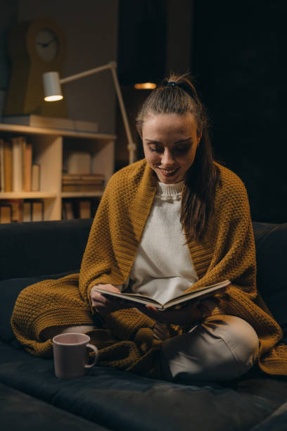 istock woman reading book at home 1318499465