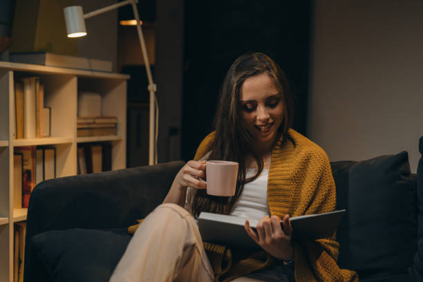 istock woman reading book at home 1318499508